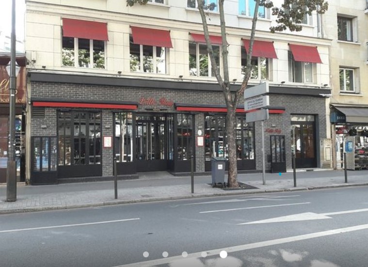 Rendez-vous chez un hypnothérapeute à Boulogne-Billancourt : étapes Façade en briques sombres et stores rouges d'un commerce à Boulogne-Billancourt, vu depuis la rue